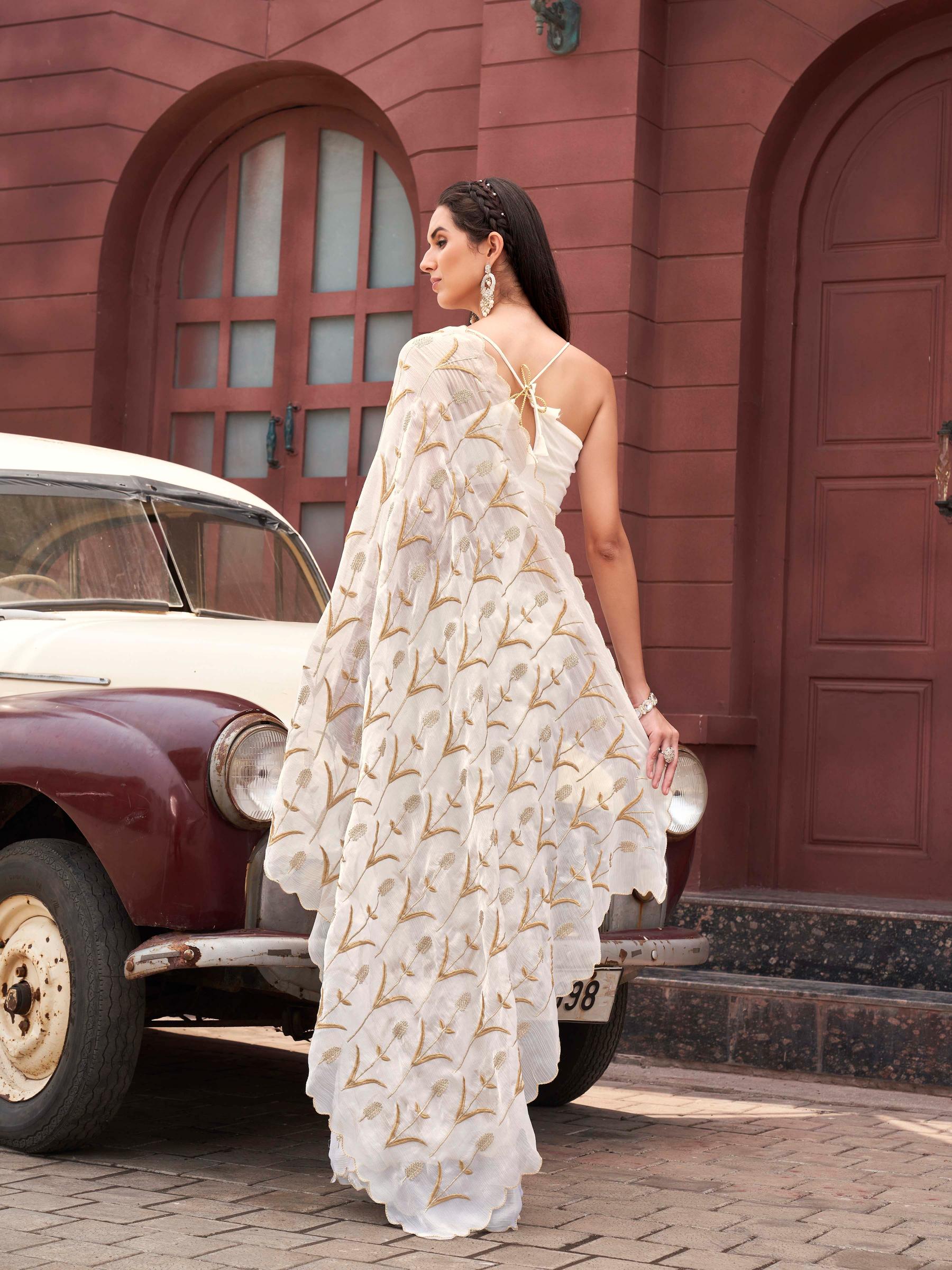 White colored jimy cho embroidered saree with scalloped border